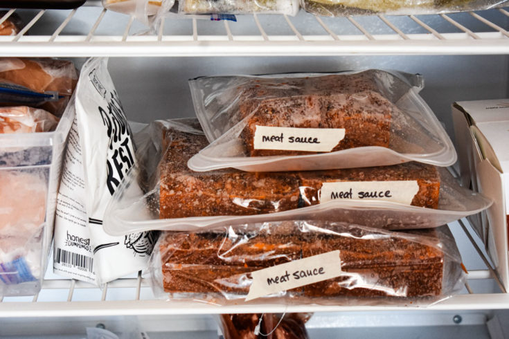 meat sauce in silicone bags laying flat in freezer and labelled