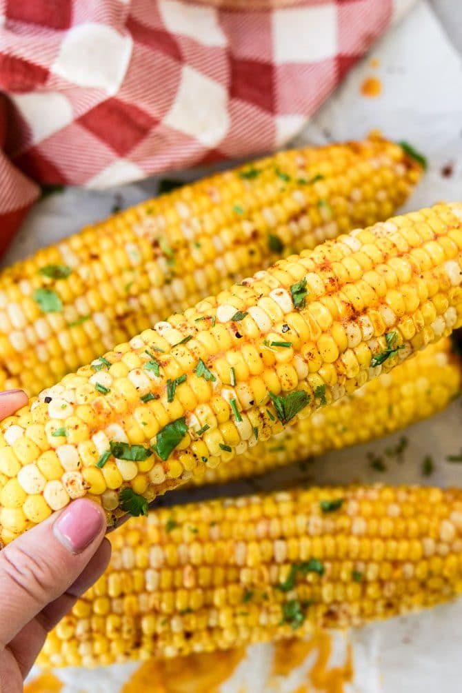 Instant Pot Chili Lime Corn on the Cob in hand