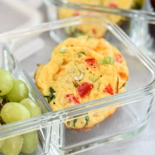 Baked Cottage Cheese Egg Muffins in meal prep container with grapes