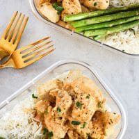 Dijon Thyme Chicken Tenders two meal prep containers with forks