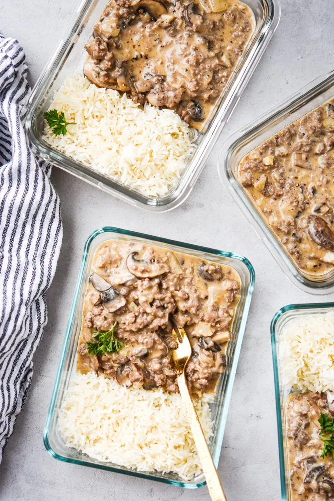 ground beef stroganoff in containers with fork in container