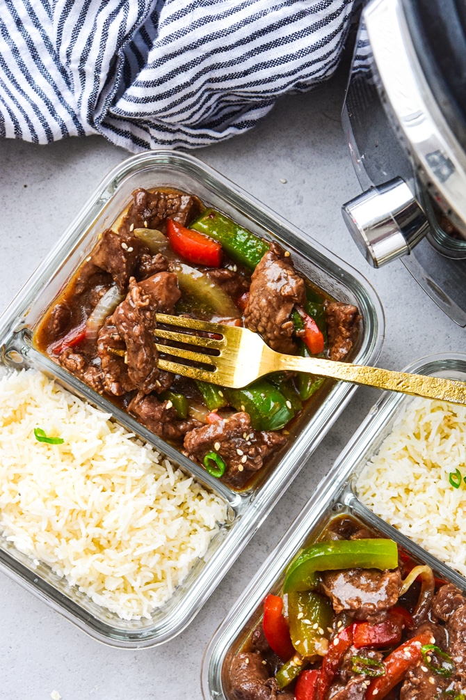 Instant Pot Pepper steak in meal prep containers with fork