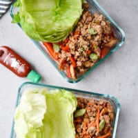 Meal prep pork lettuce wraps in 2 containers flatlay