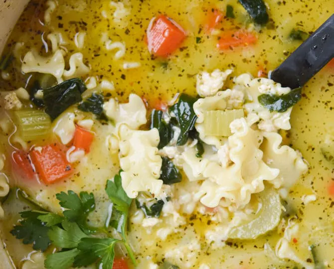 chicken lasagna soup close up in a ladle