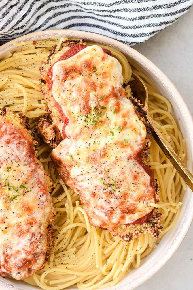 Chicken parm with spaghetti and fork