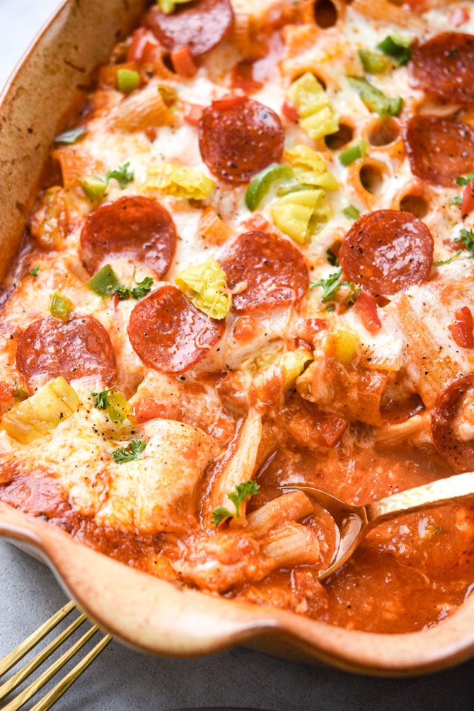 pizza pasta bake with gold spoon