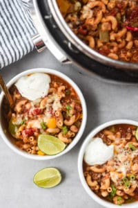 chili mac hero shot with instant pot and 2 bowls plated