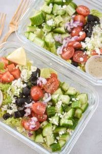 2 greek salad meal preps side by side portrait