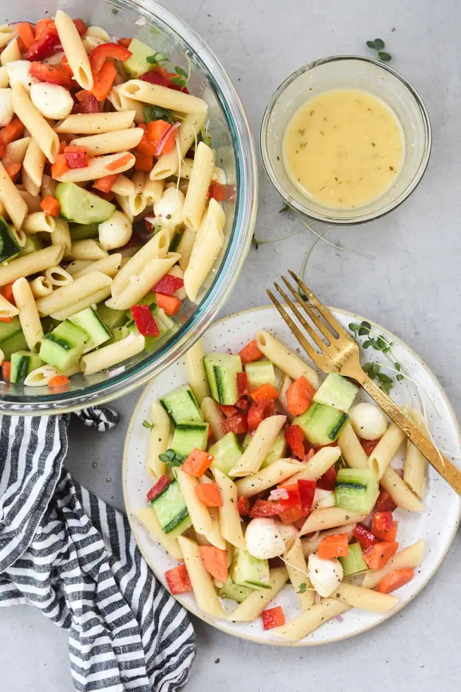 pasta salad from above plated with bowl of salad