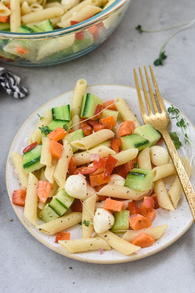 pasta salad plated with gold fork