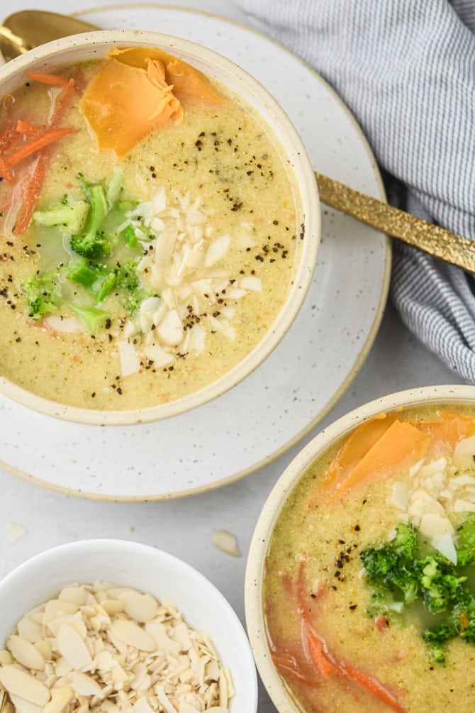 veggie loaded broccoli cheddar soup in 2 bowls flatlay
