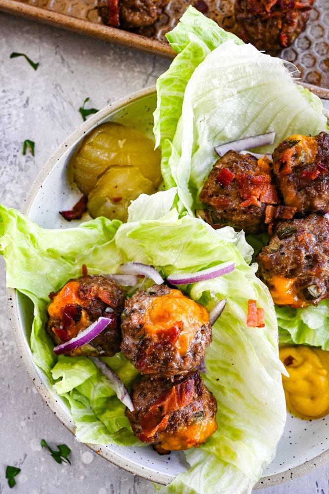 meatballs in lettuce cups with pickles and onion