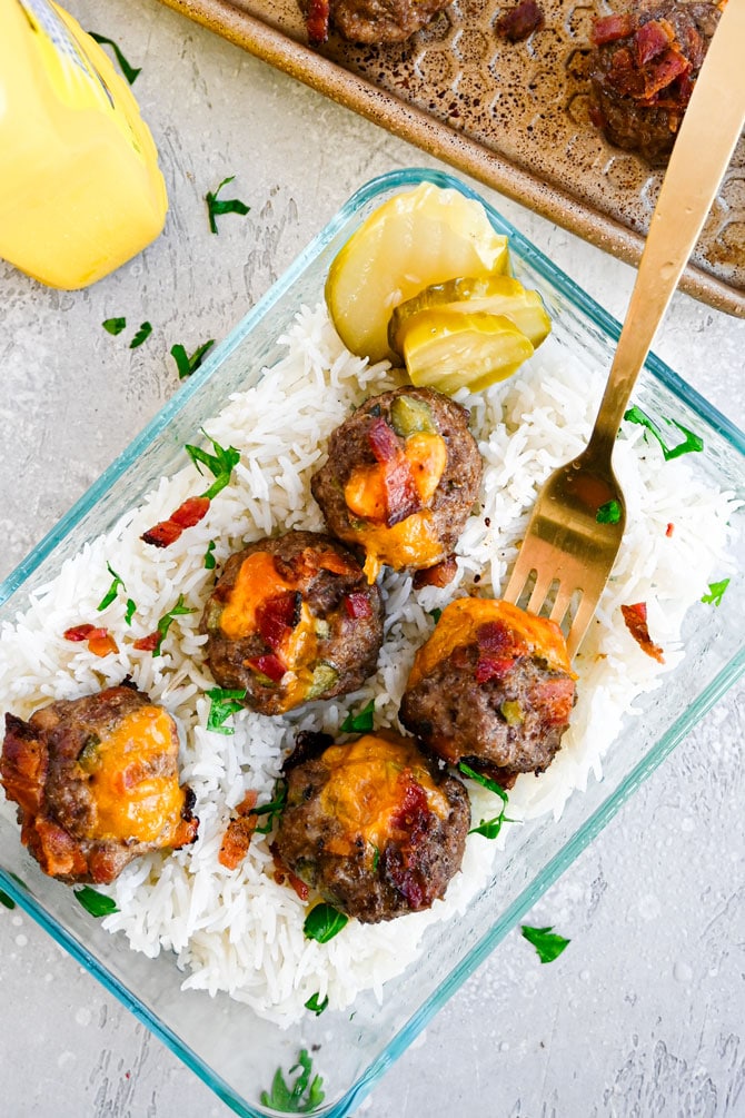 meatballs in meal prep container with rice and fork 