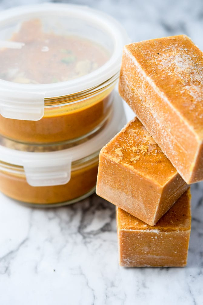 Carrot soup frozen in container and cubes